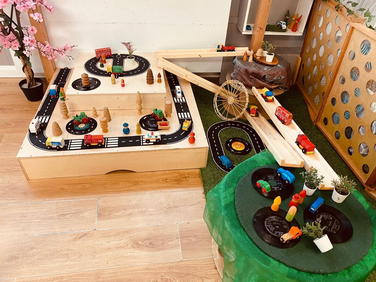 A wooden table with a lot of toy cars on it.