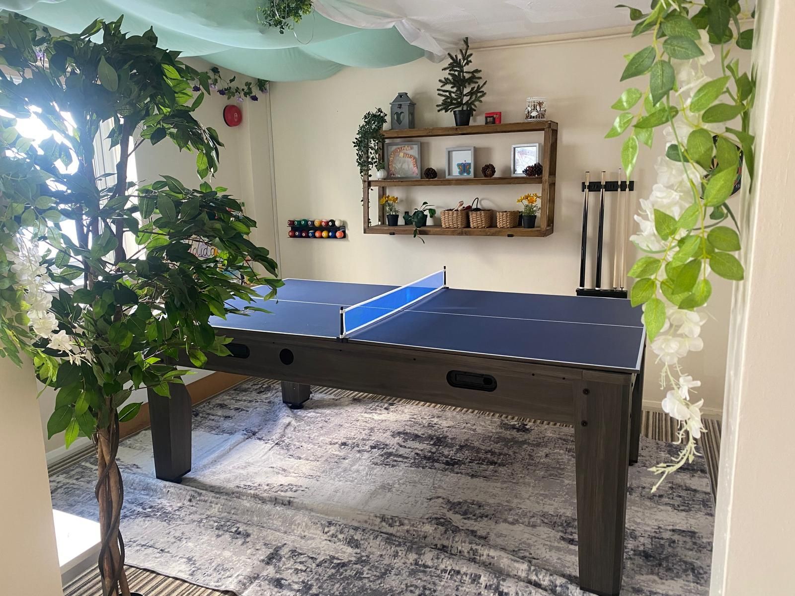 A room with a pool table and a ping pong table