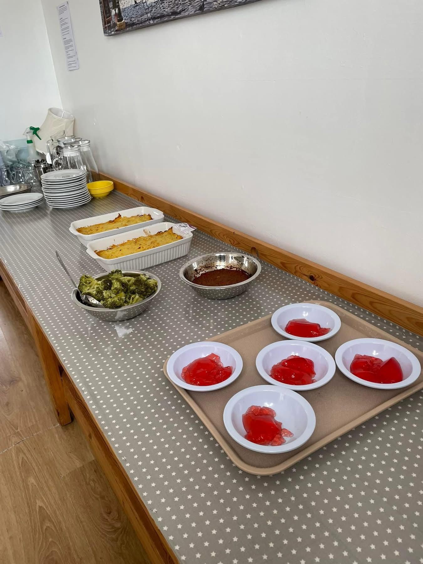 A table with a tray of bowls of food on it