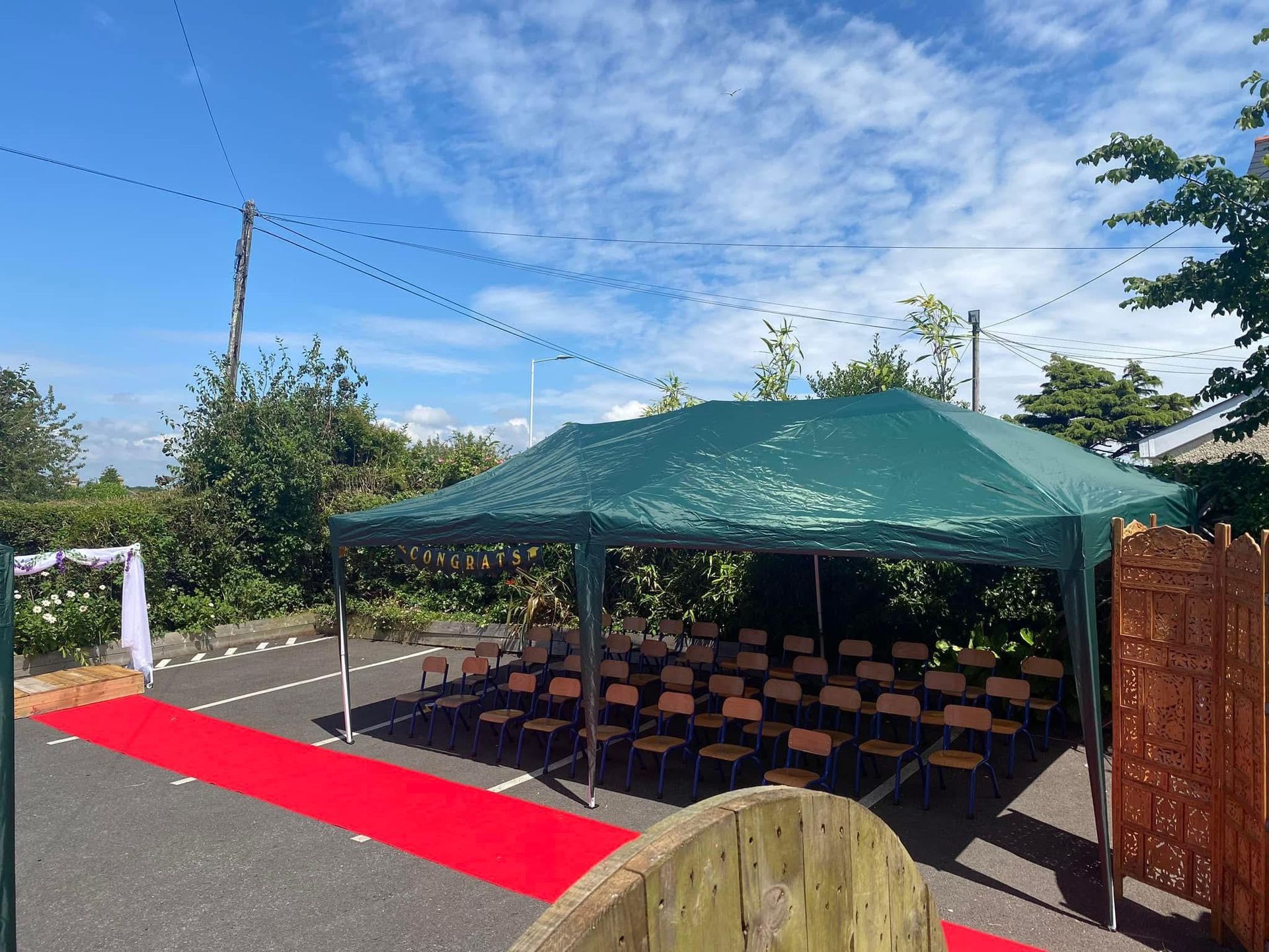 A red carpet is leading to a green tent