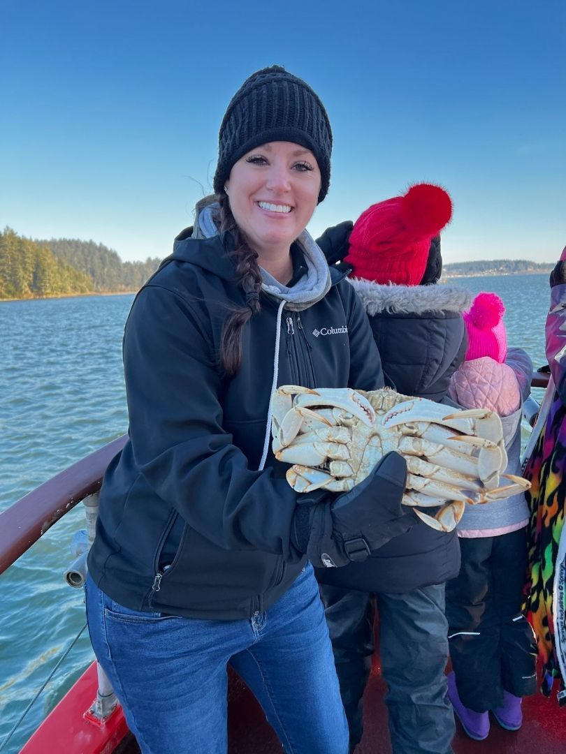 A woman is holding a piece of bread on a boat.