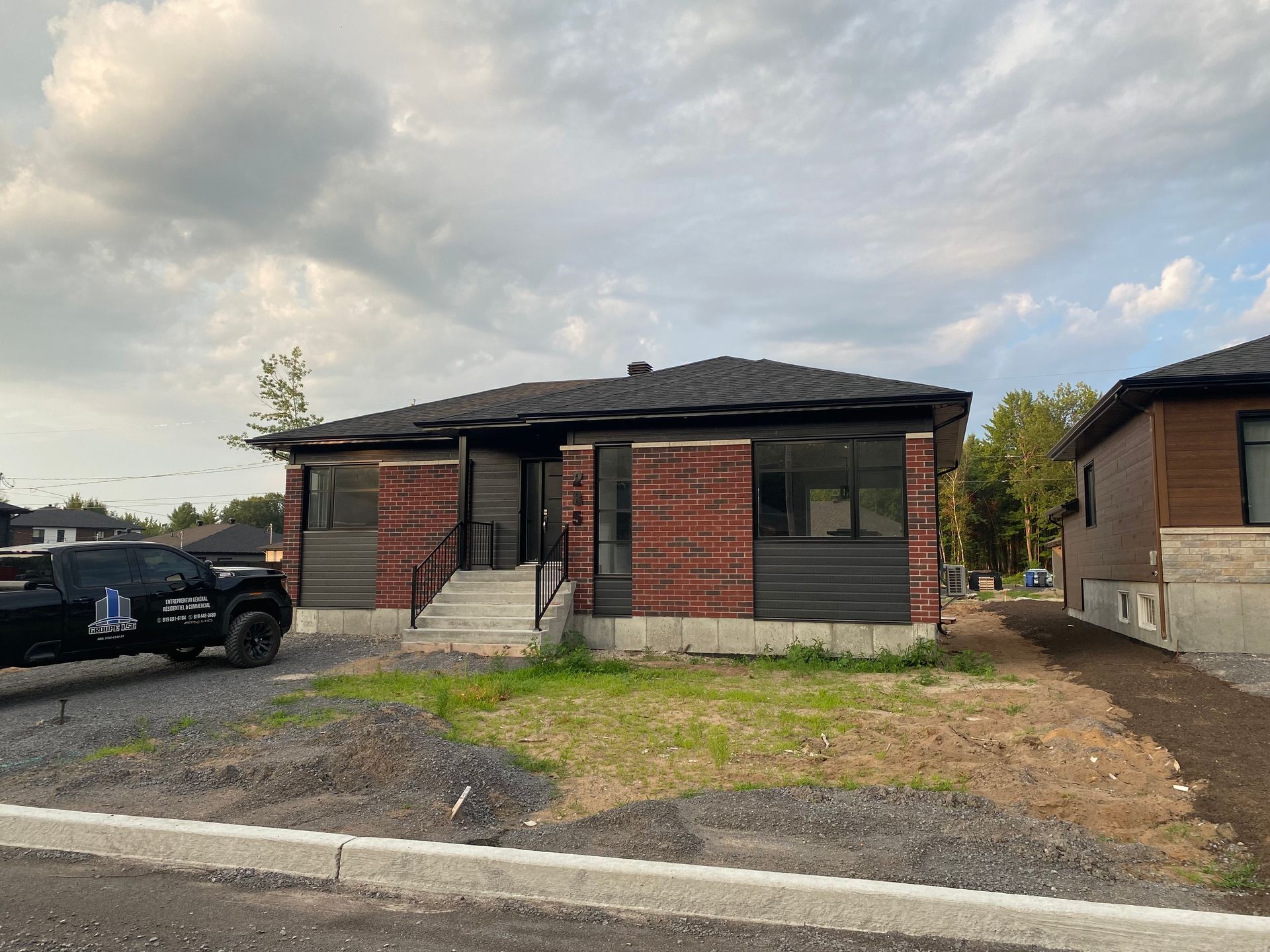 Un camion est garé devant une maison en construction.