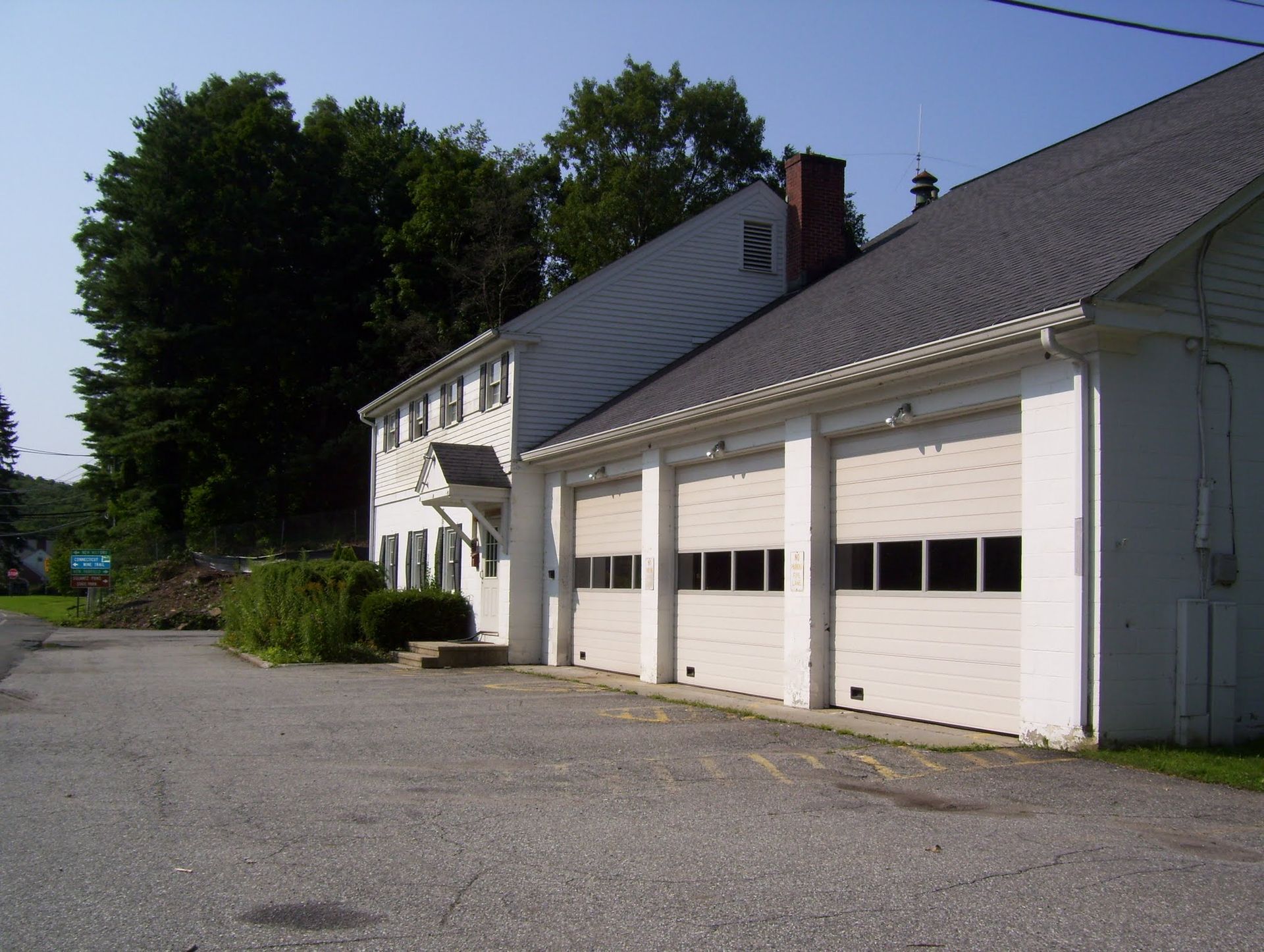 A white building with a lot of garage doors