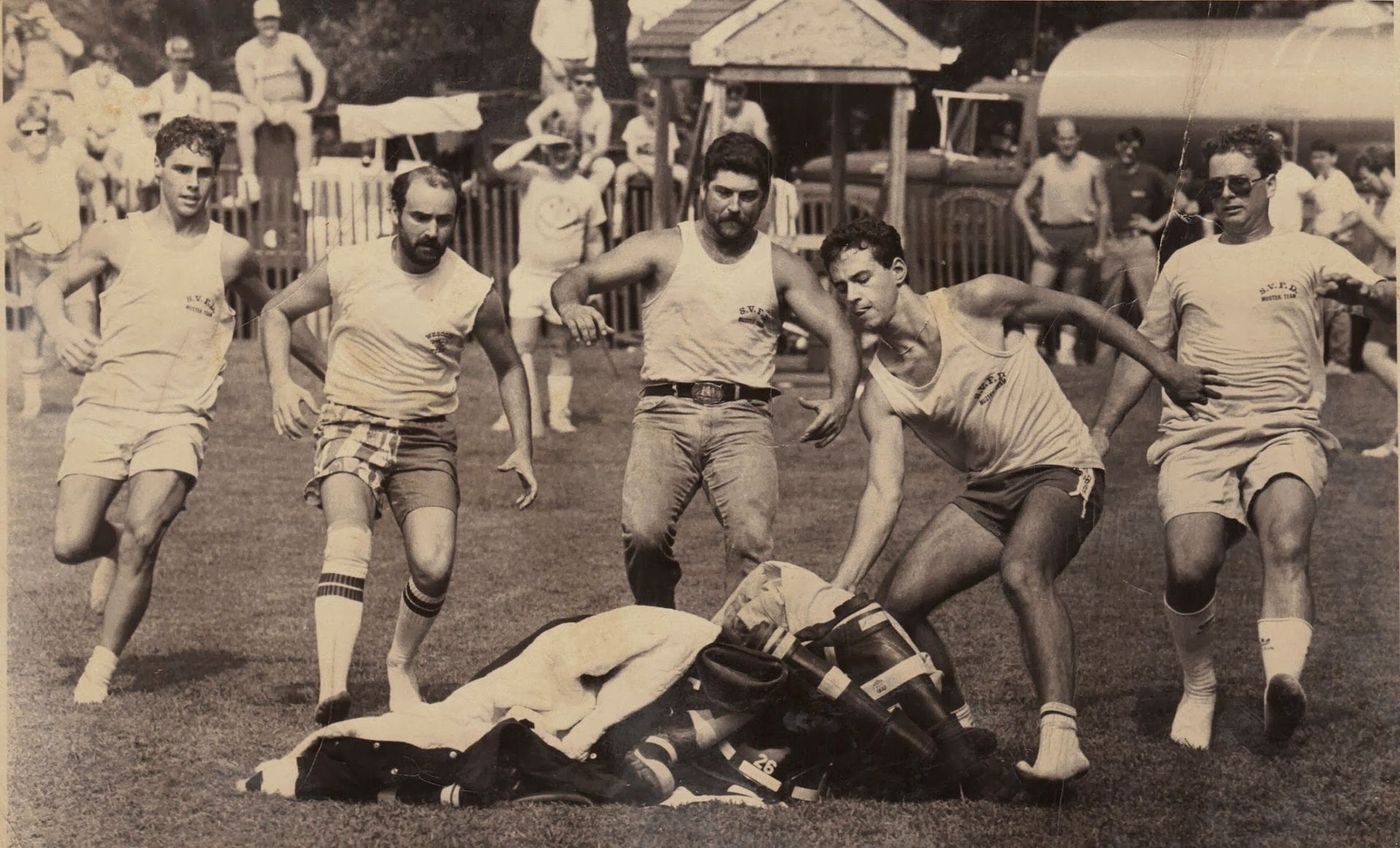 A black and white photo of a group of men playing rugby