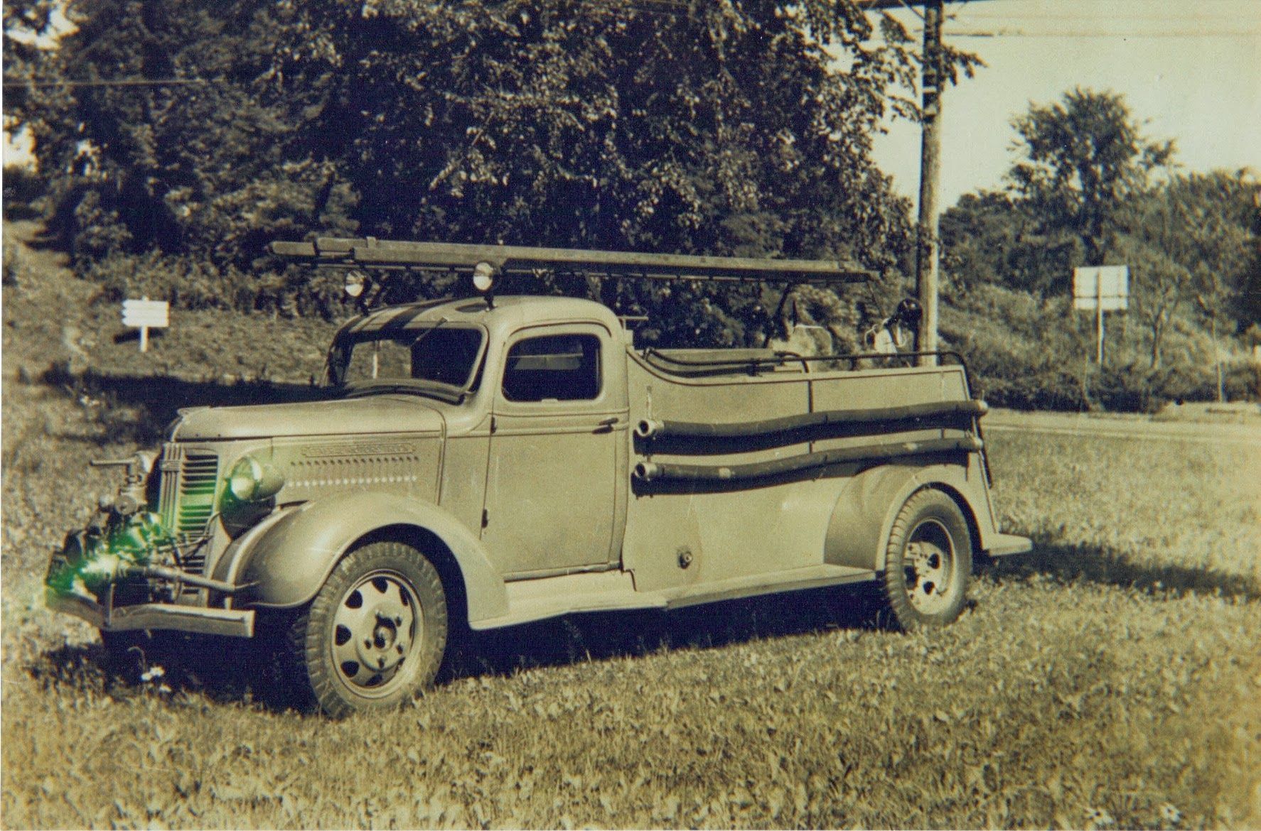 A black and white photo of an old fire truck