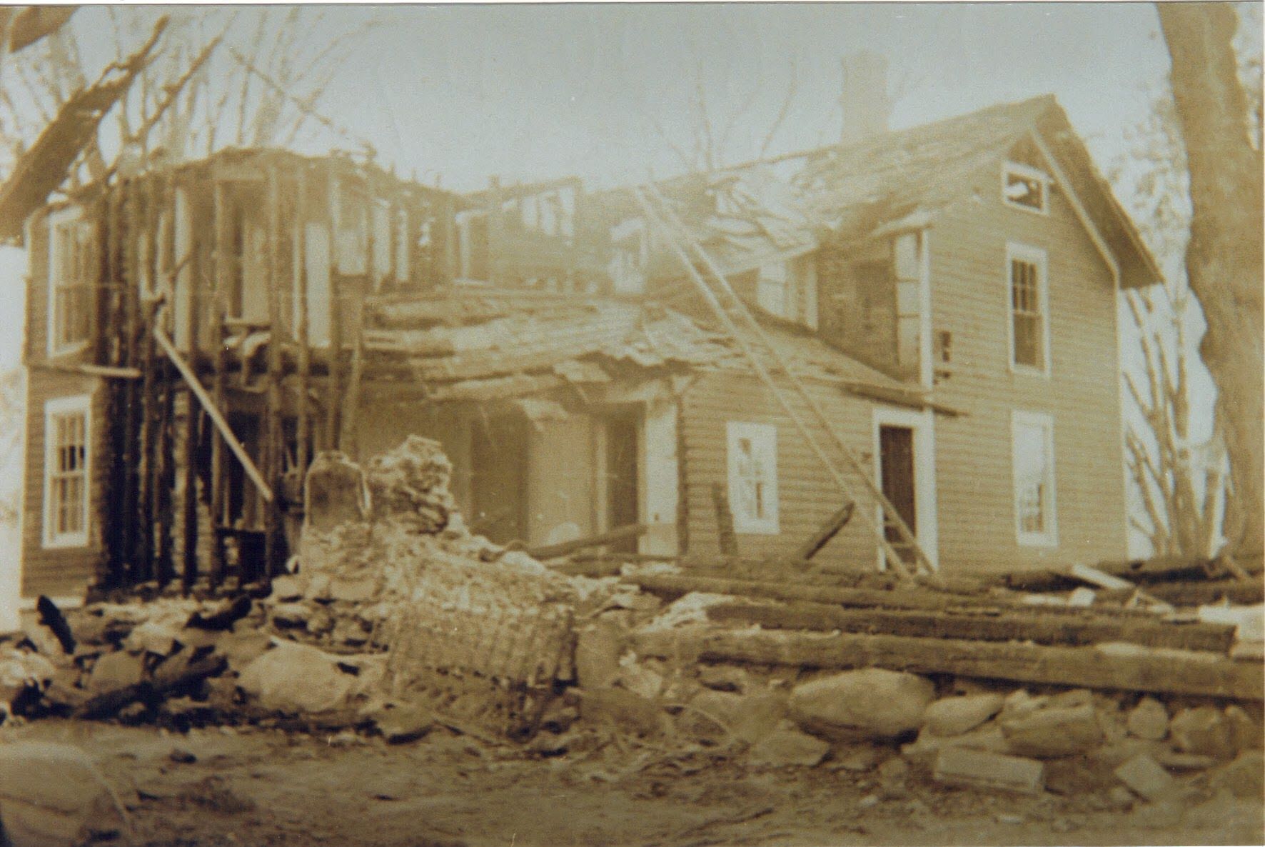 A black and white photo of a house under construction