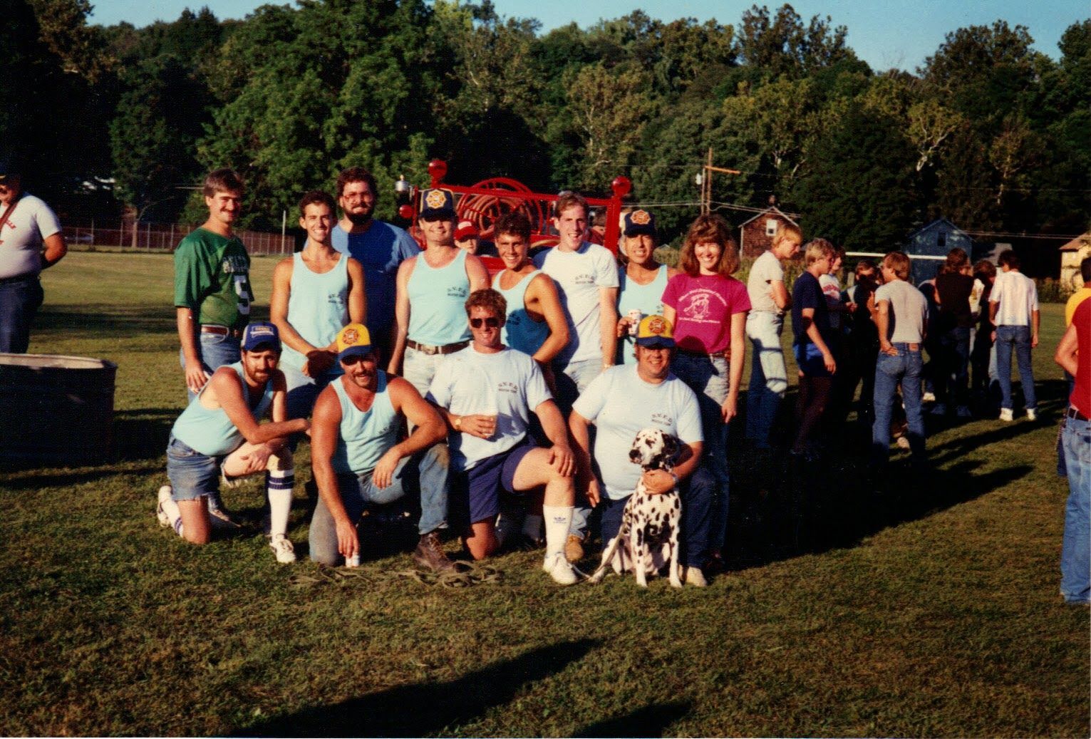 A group of people posing for a picture with a dog