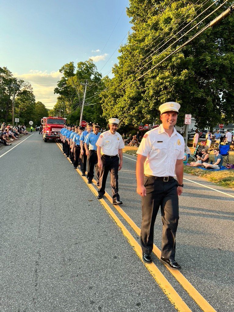 A group of men are marching down a street in a parade.