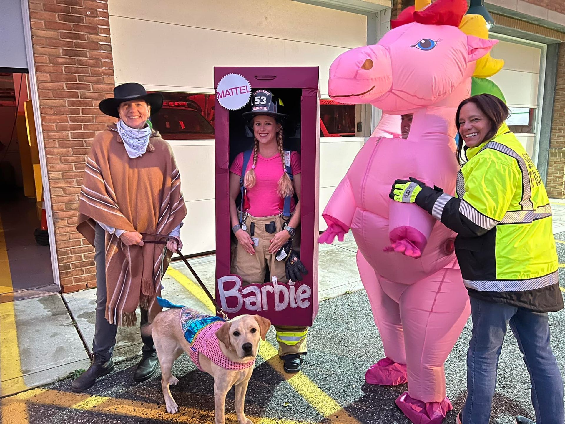A woman in a pink barbie costume is standing next to a woman in a pink dragon costume.
