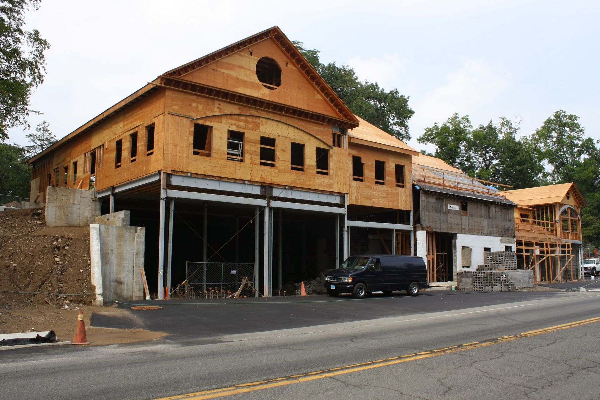 A van is parked in front of a building under construction