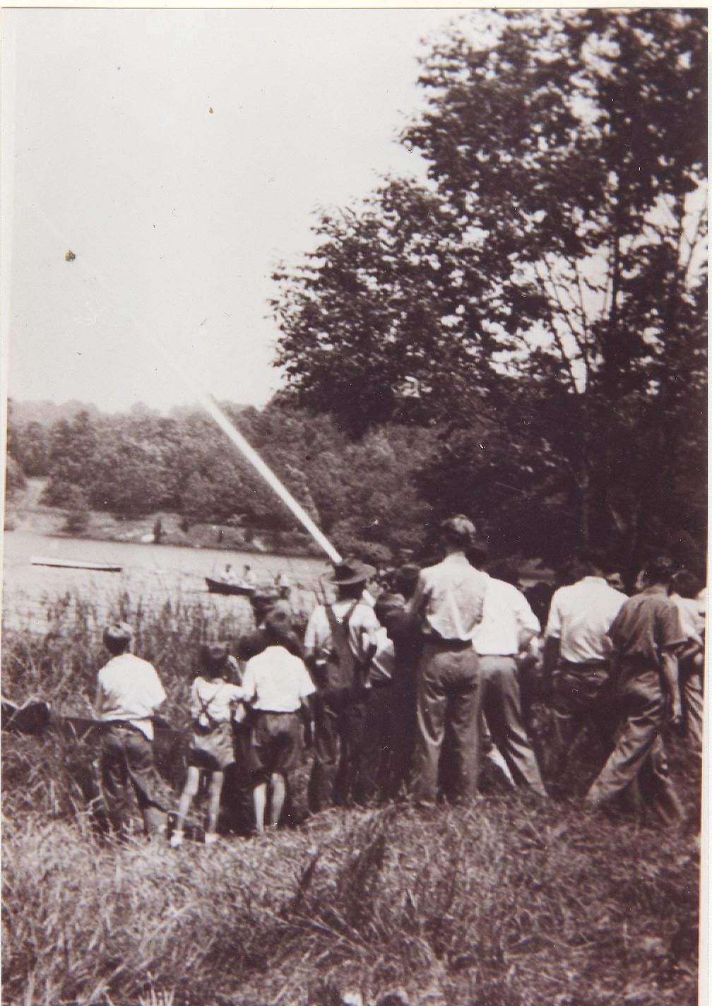 A black and white photo of a group of people in a field