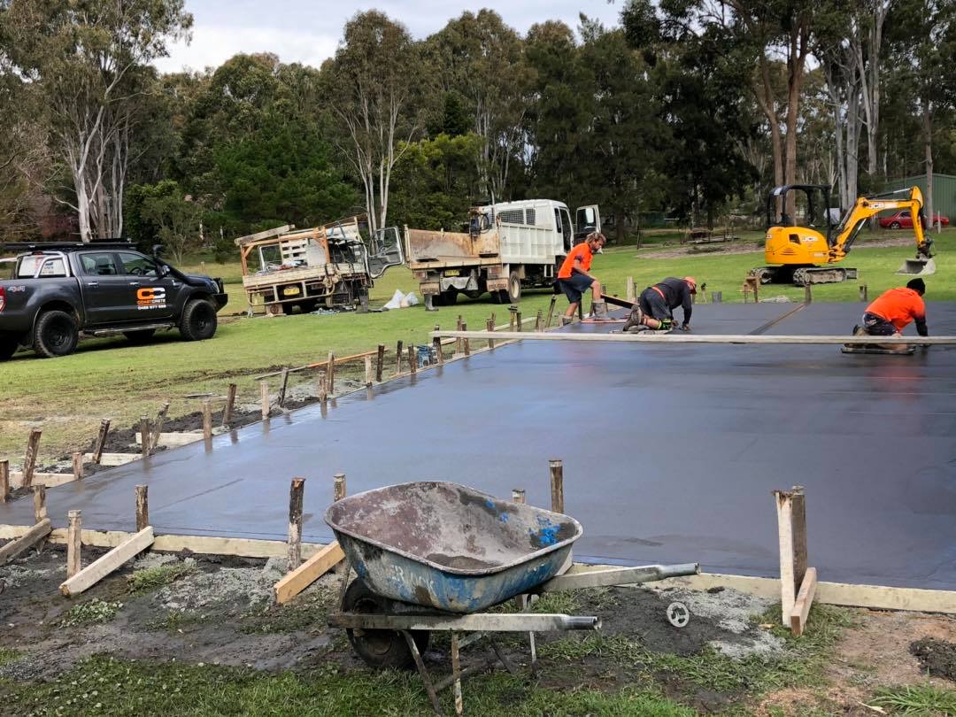 Three Workers Working on Shed Slab — Medowie, NSW — Coastcrete