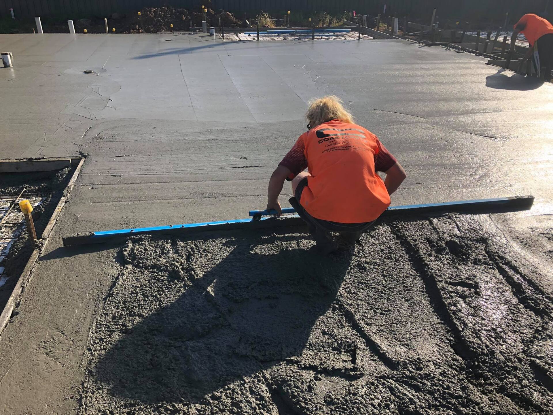 Worker Spreading the Concrete — Medowie, NSW — Coastcrete