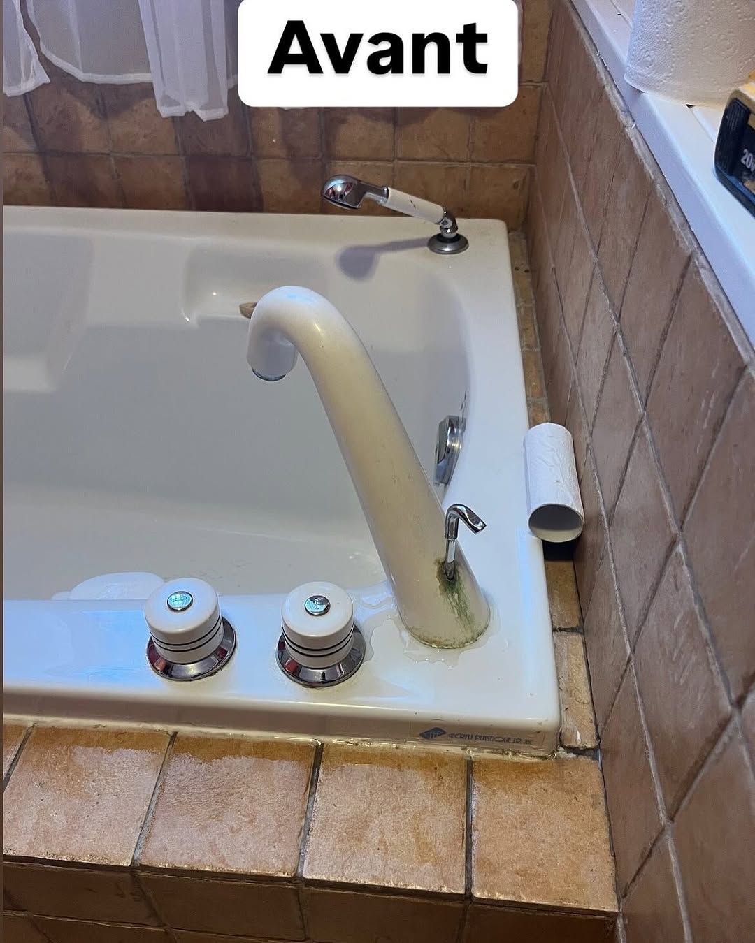 Une baignoire avec un robinet et un panneau indiquant avant