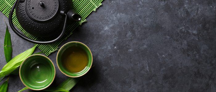 A warm cup of green tea with gentle steam rising, offering antioxidants to aid the body’s detoxification.