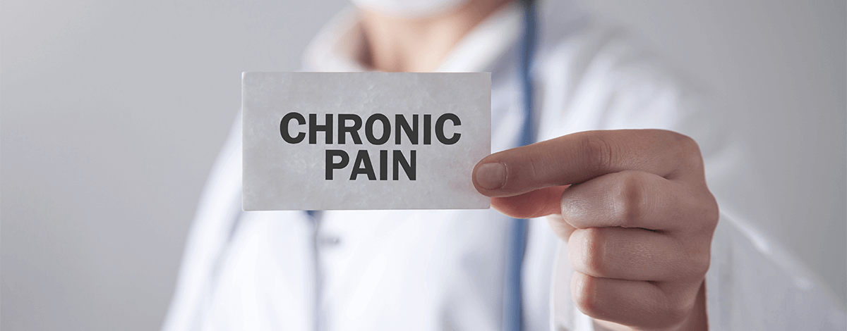 Medical professional holding a document with the inscription Chronic Pain