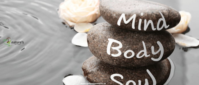 Three rocks symbolising the balance of body, mind, and spirit in holistic health.