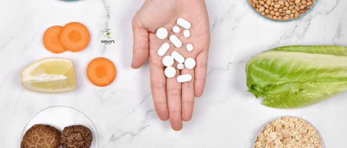 A person's hand displaying a selection of natural supplements, highlighted by soft natural lighting.