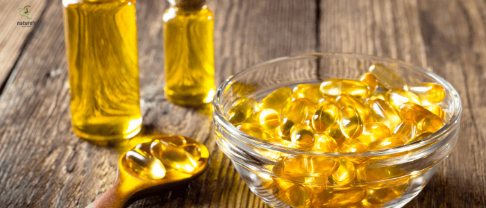 Artistic arrangement of various natural supplements including fish oil capsules, turmeric powder, and probiotic pills.