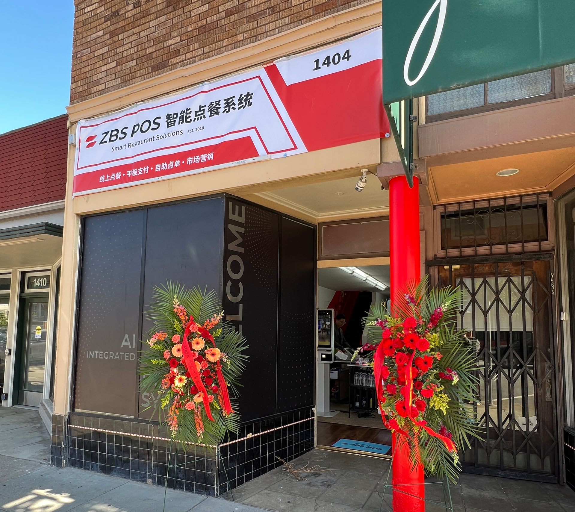 2 tv screen displaying ZBS POS welcome sign for office grand opening.