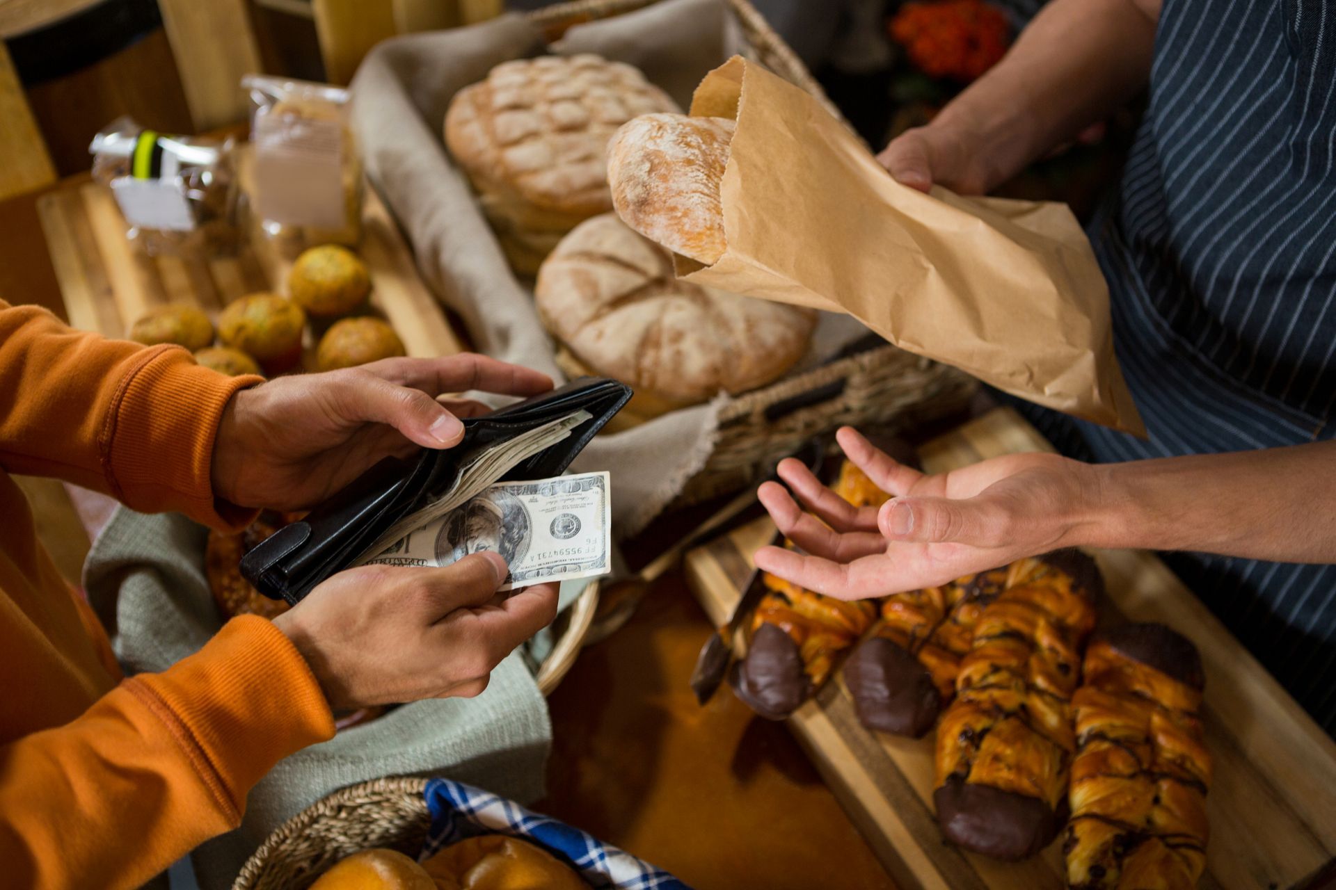 exchanging cash for food in bakery