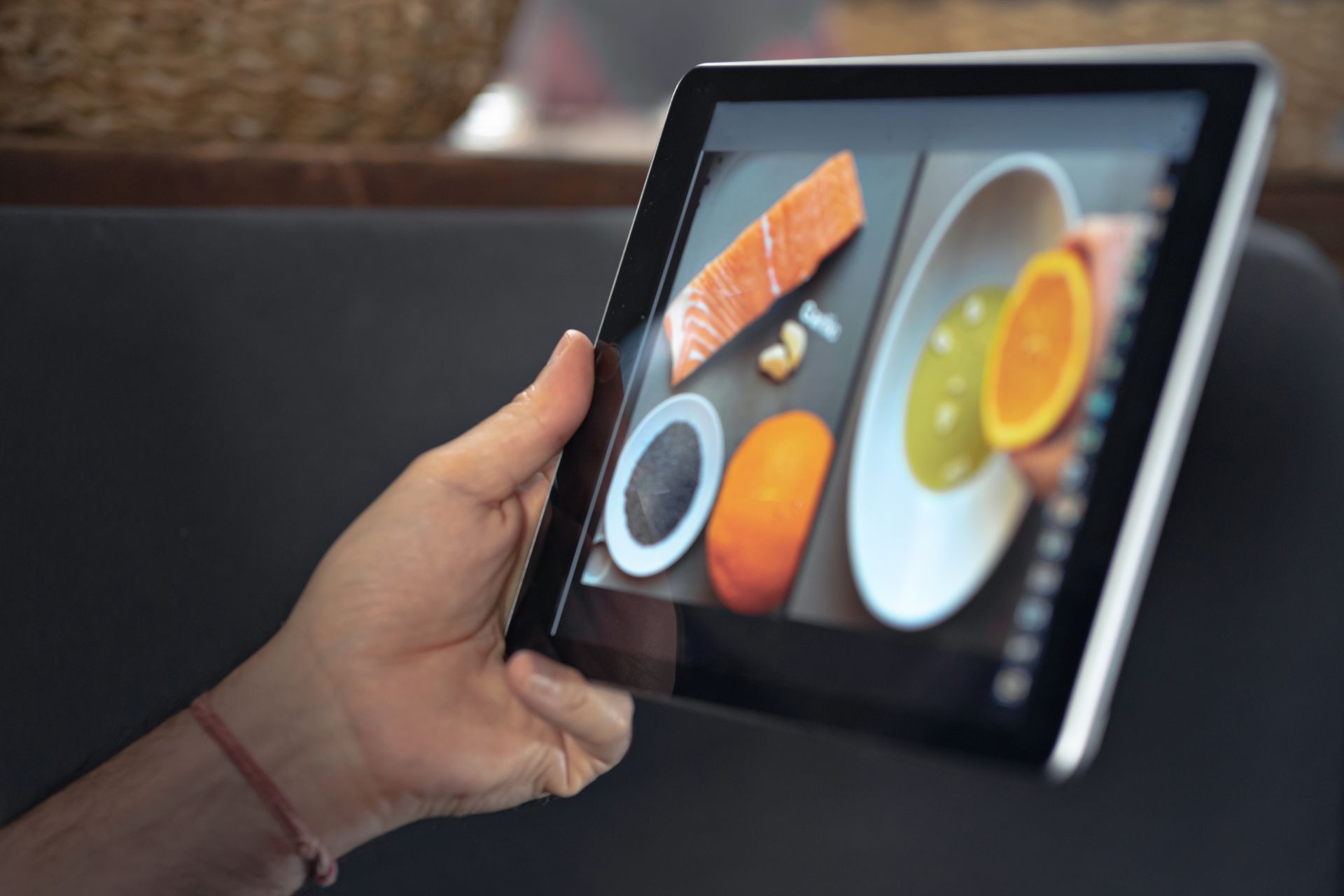 a guest is viewing the dishes on the tablet at a sushi restaurant