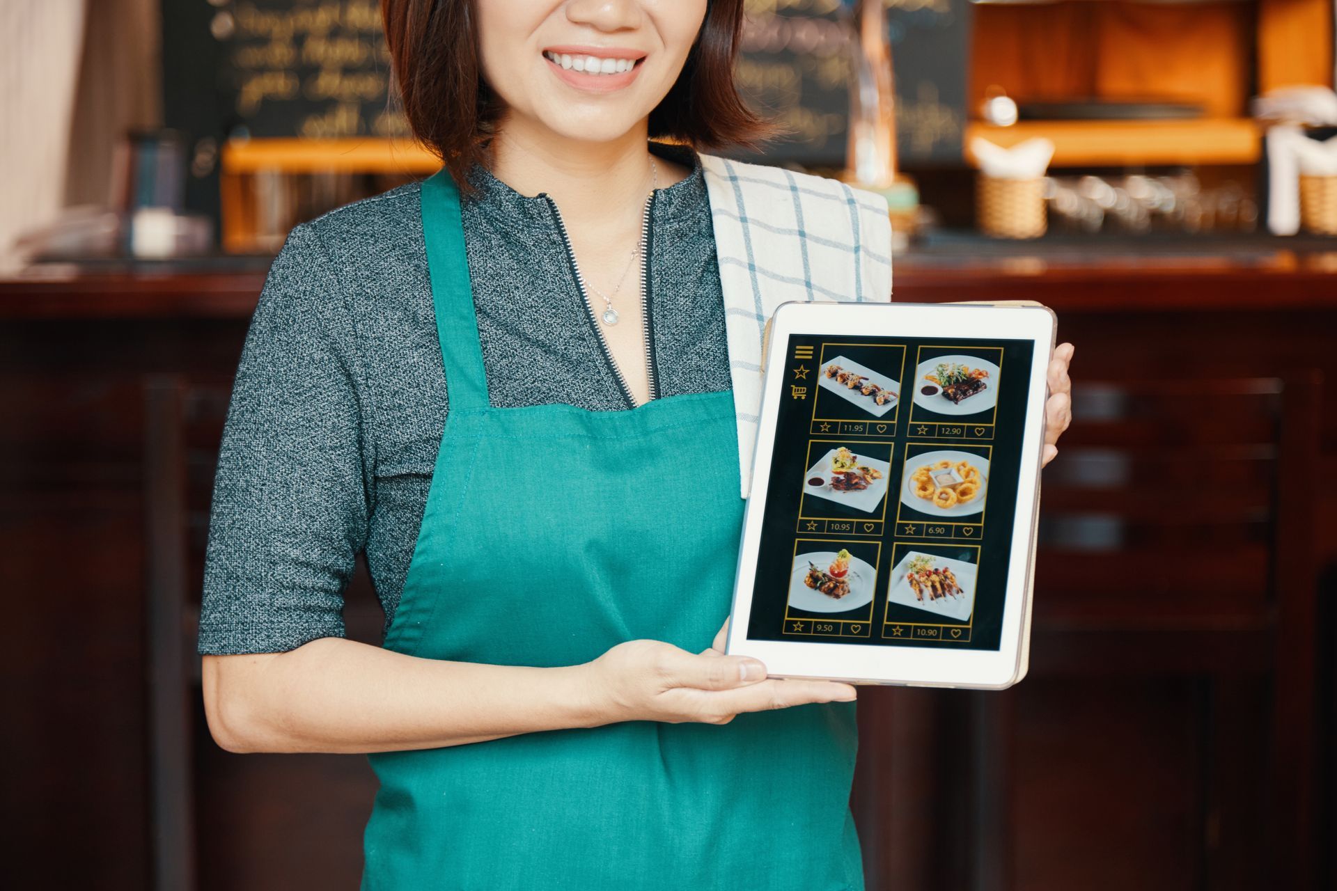 a server is showing the menu to the guests at a sushi restaurant