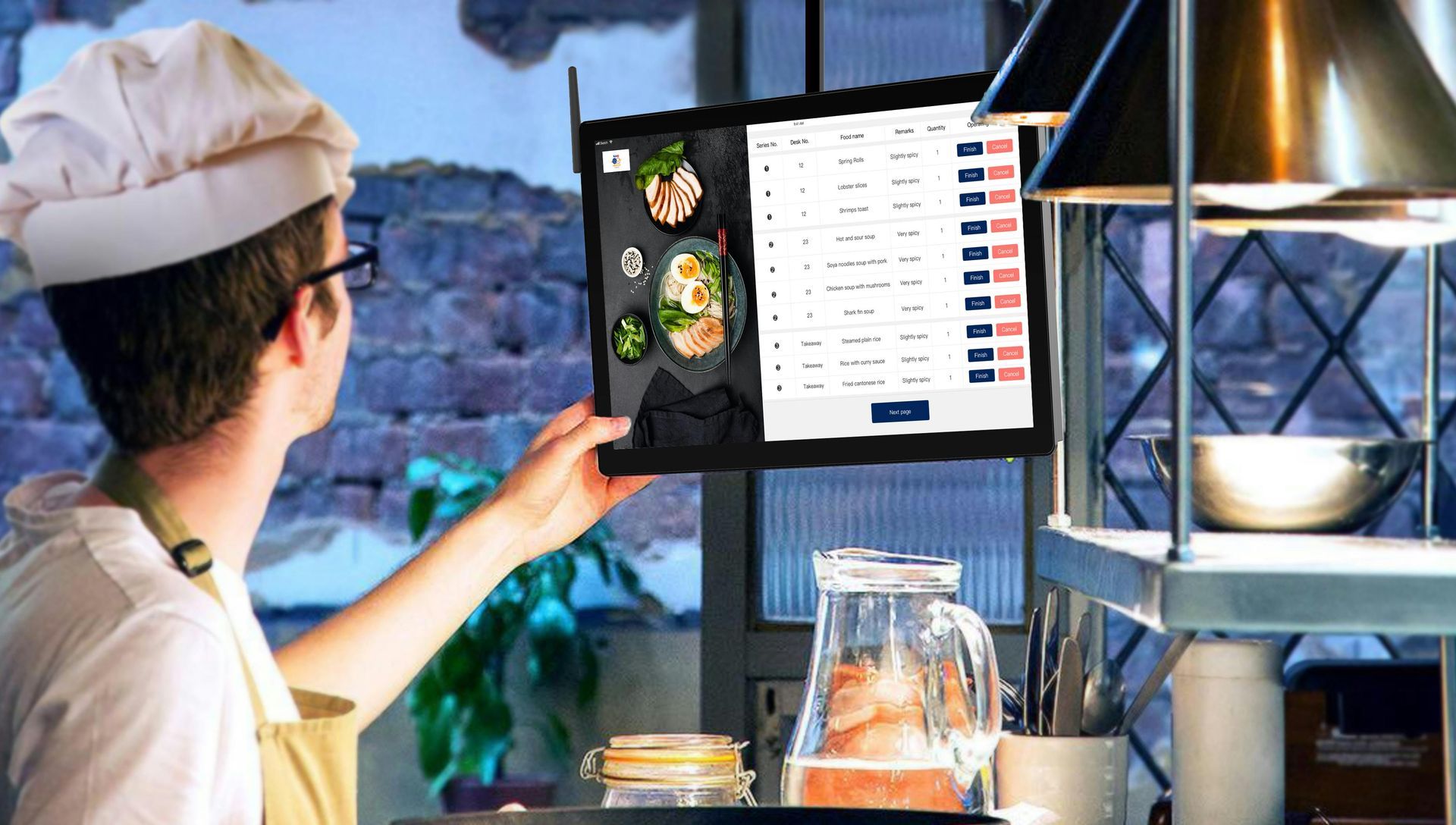 A chef is checking orders showing on the kitchen display system in the sushi restaurant kitchen