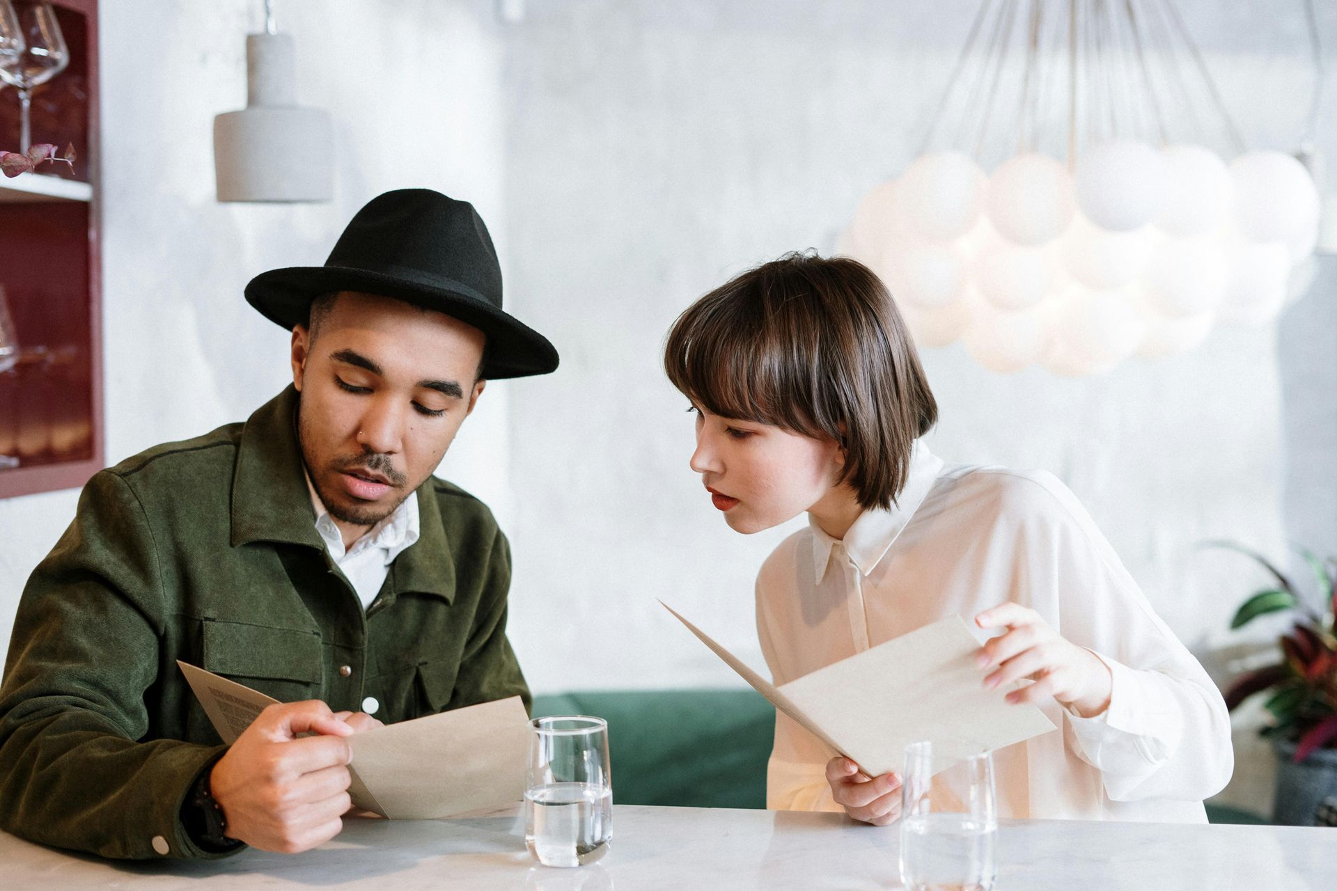 customers in restaurant look at menu at their table