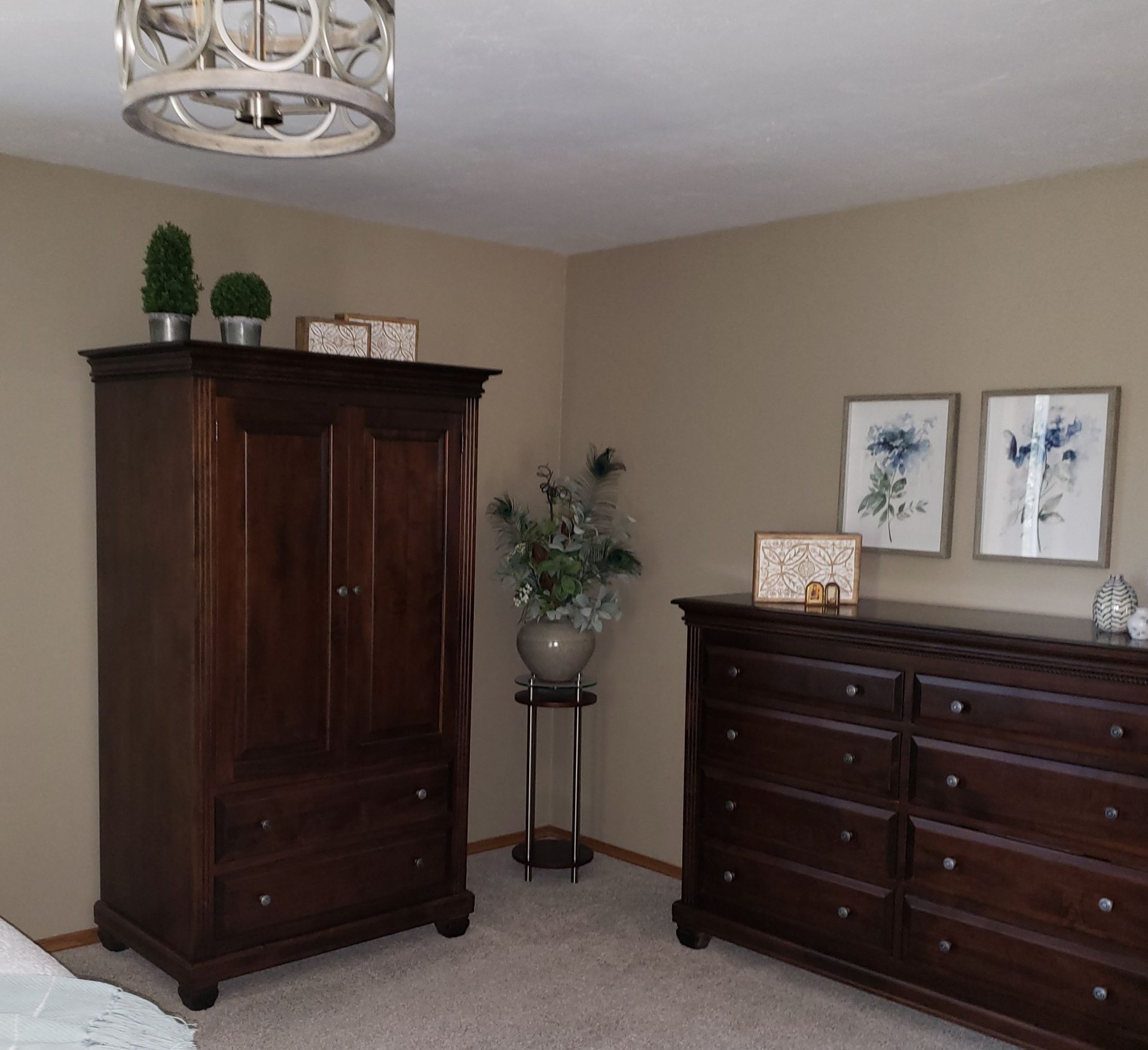A bedroom with two dressers and a wardrobe