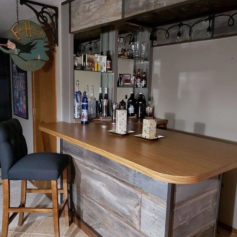 A wooden bar with bottles and candles on it