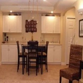 A kitchen with a table and chairs in it