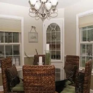A dining room with a table and chairs and a chandelier.