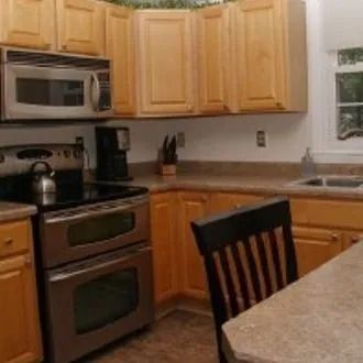 A kitchen with stainless steel appliances and wooden cabinets