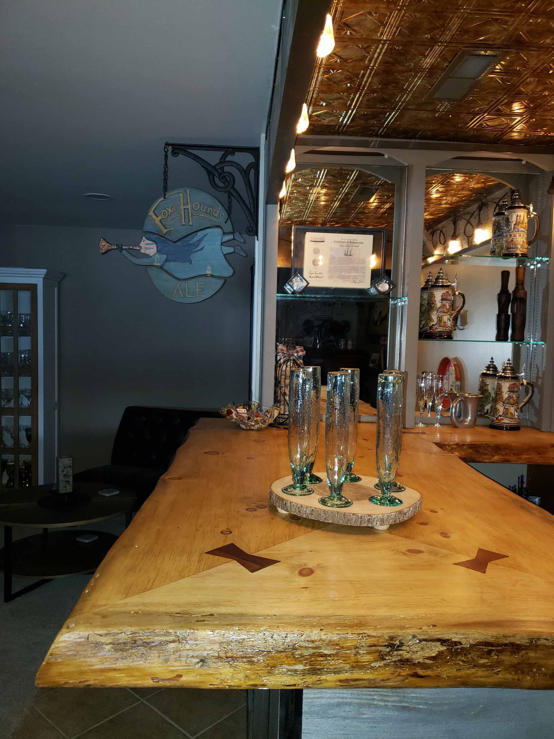 A wooden bar with glasses on top of it