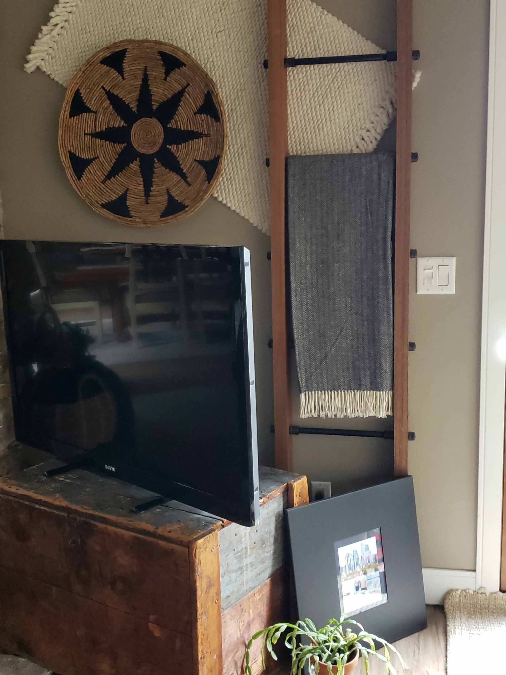 A flat screen tv is sitting on a wooden stand in a living room.