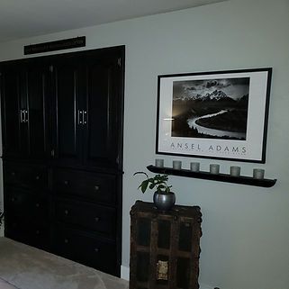 A room with a picture on the wall that says angel adams