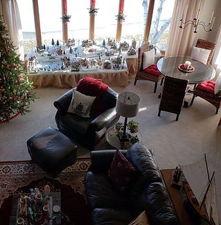 An aerial view of a living room with a christmas tree in the background