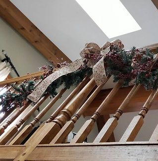 A wooden railing with christmas decorations on it