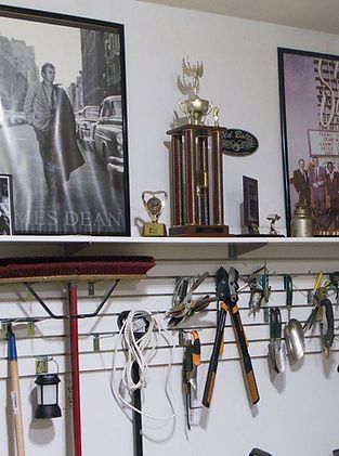 A shelf with a picture of a man and a trophy on it