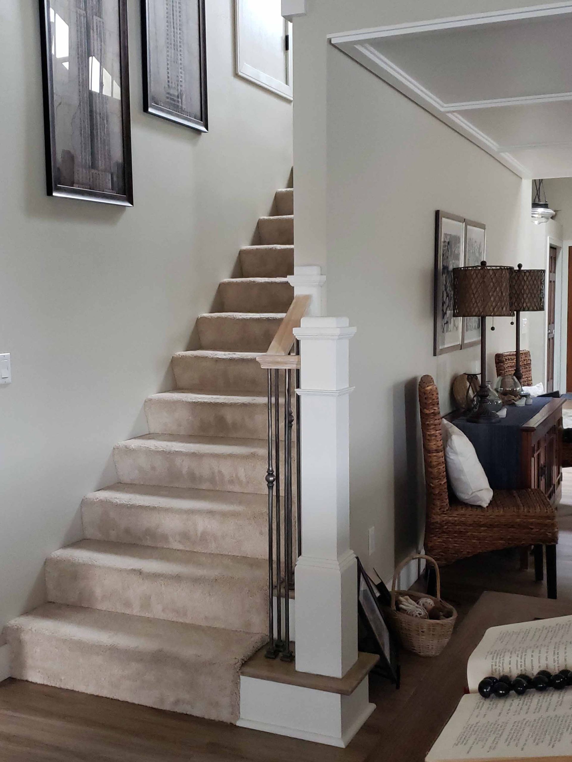 A living room with a staircase leading up to the second floor