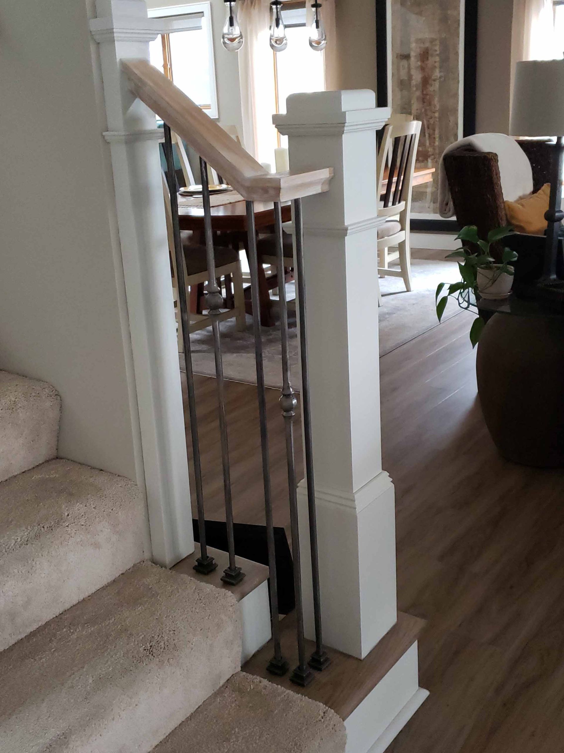Stairs leading up to a living room with a table and chairs