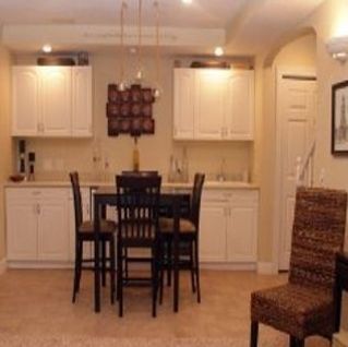 A kitchen with a table and chairs in it