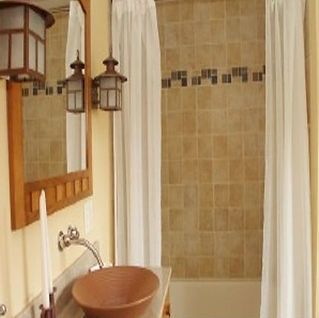 A bathroom with a sink a mirror and a shower curtain