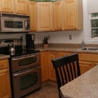 A kitchen with stainless steel appliances and wooden cabinets