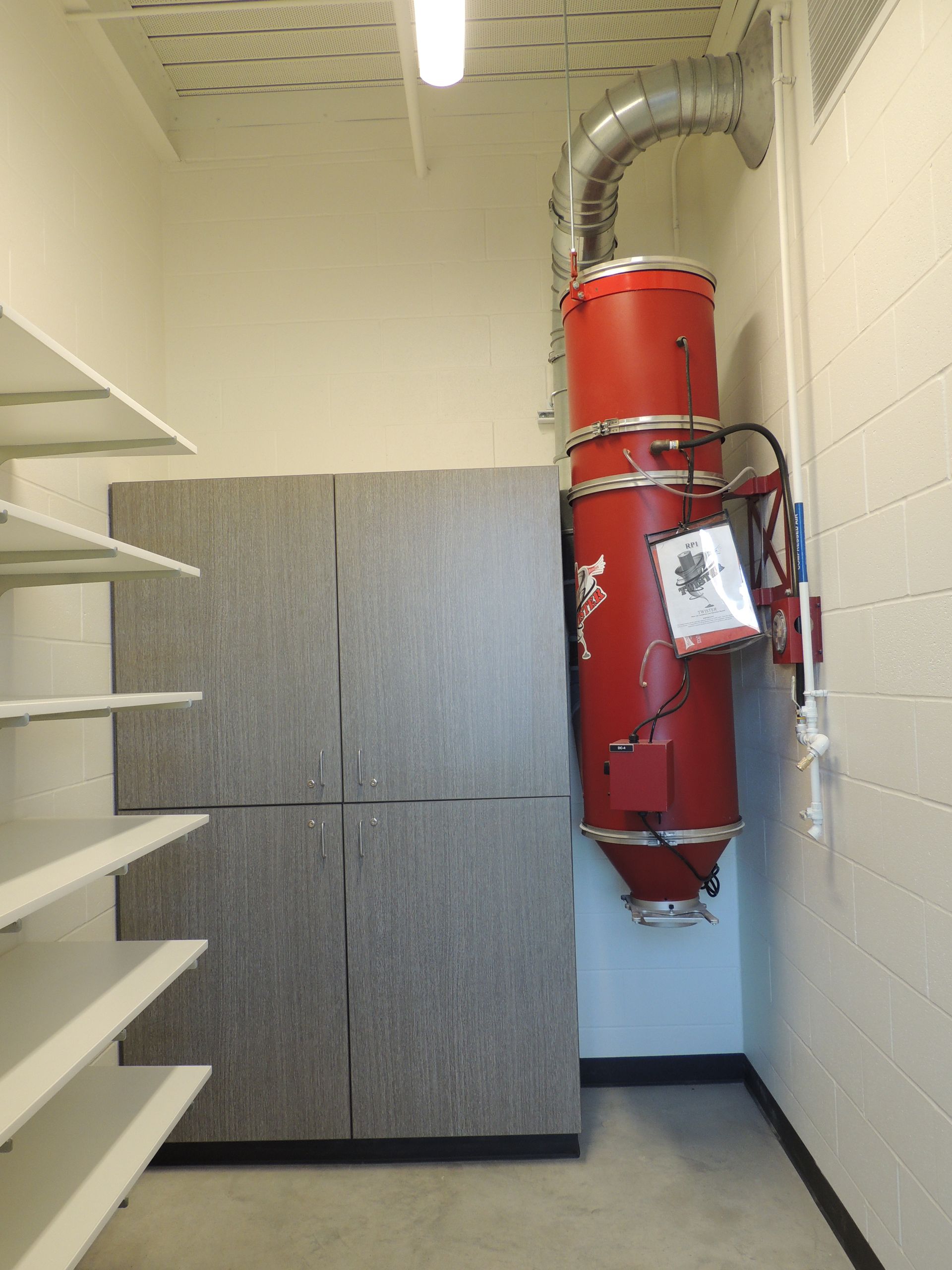 A room with shelves and a large red object on the wall