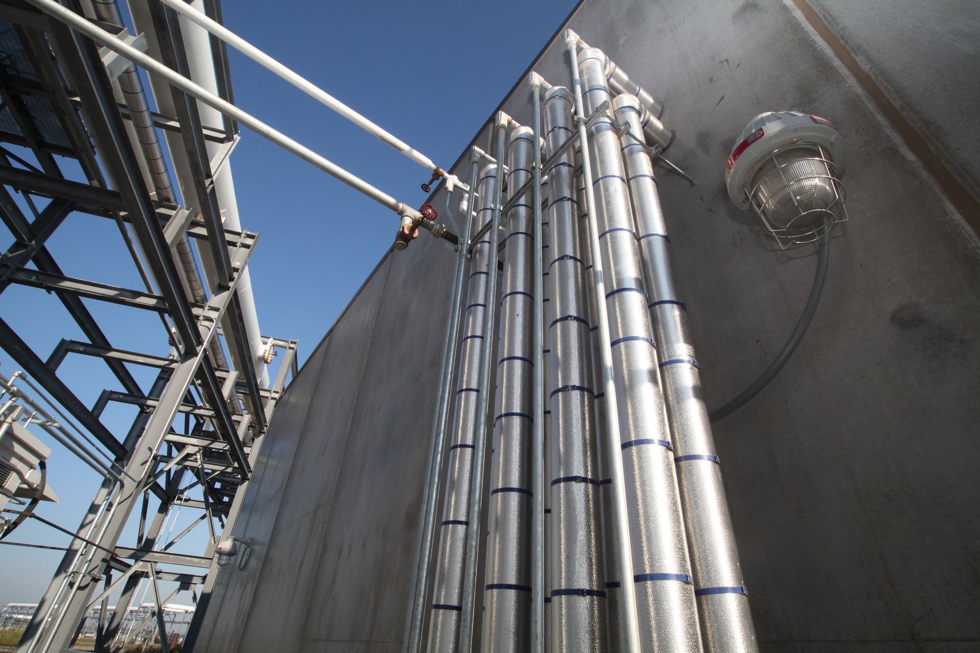 A bunch of metal pipes are attached to a wall