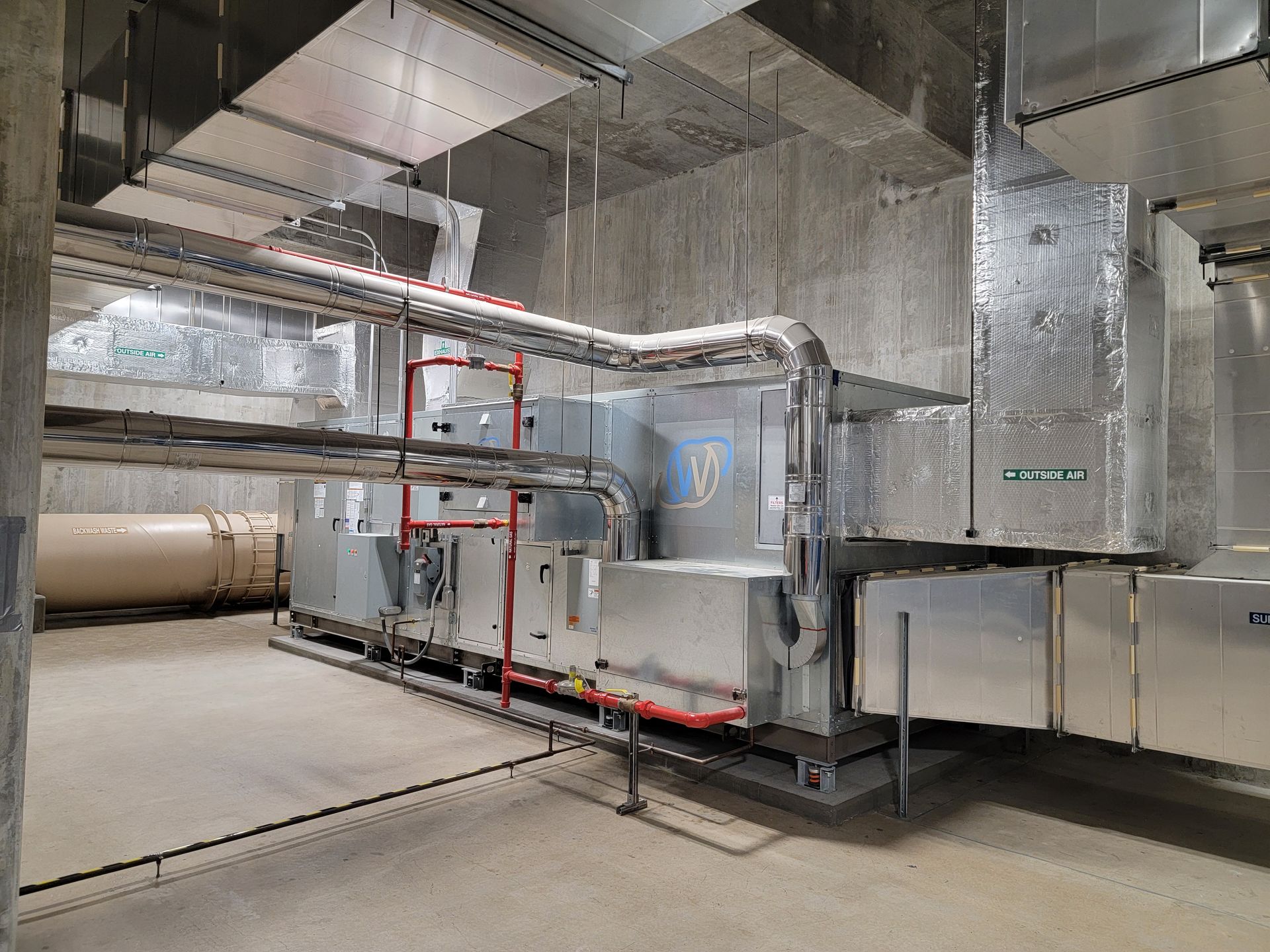 A large electrical box is sitting on the side of a building.