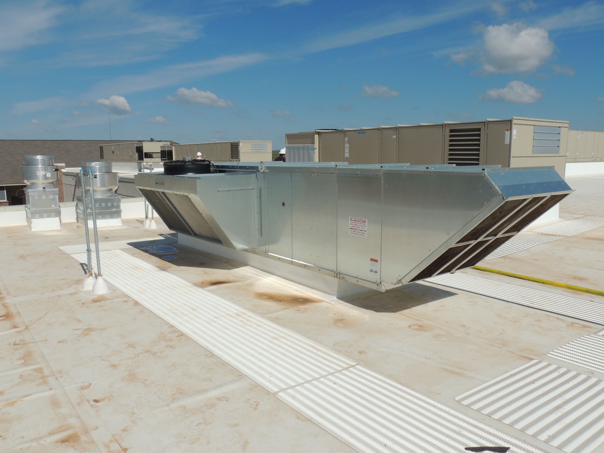 A large metal structure is sitting on top of a roof.
