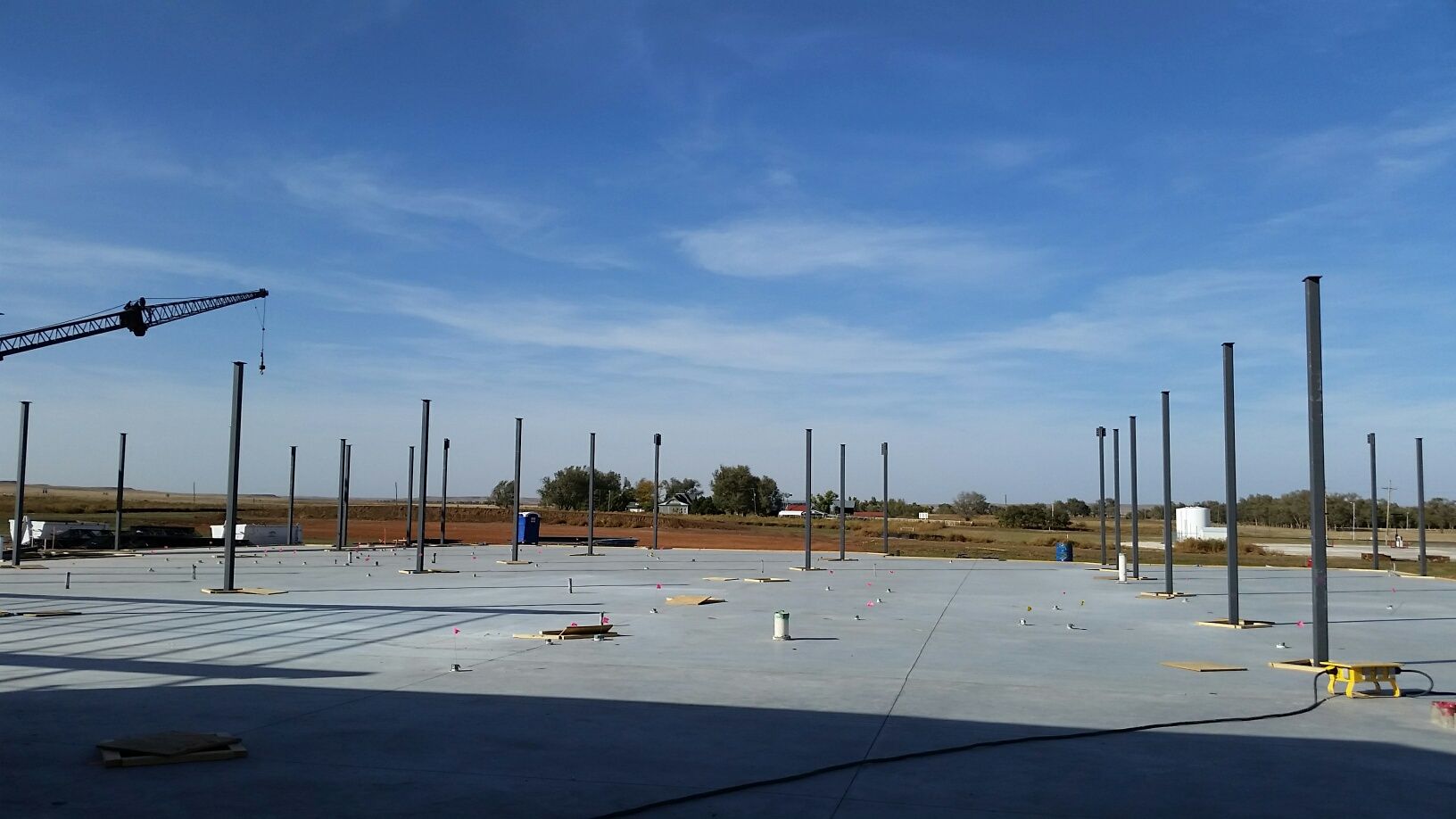 A building under construction with a blue sky in the background